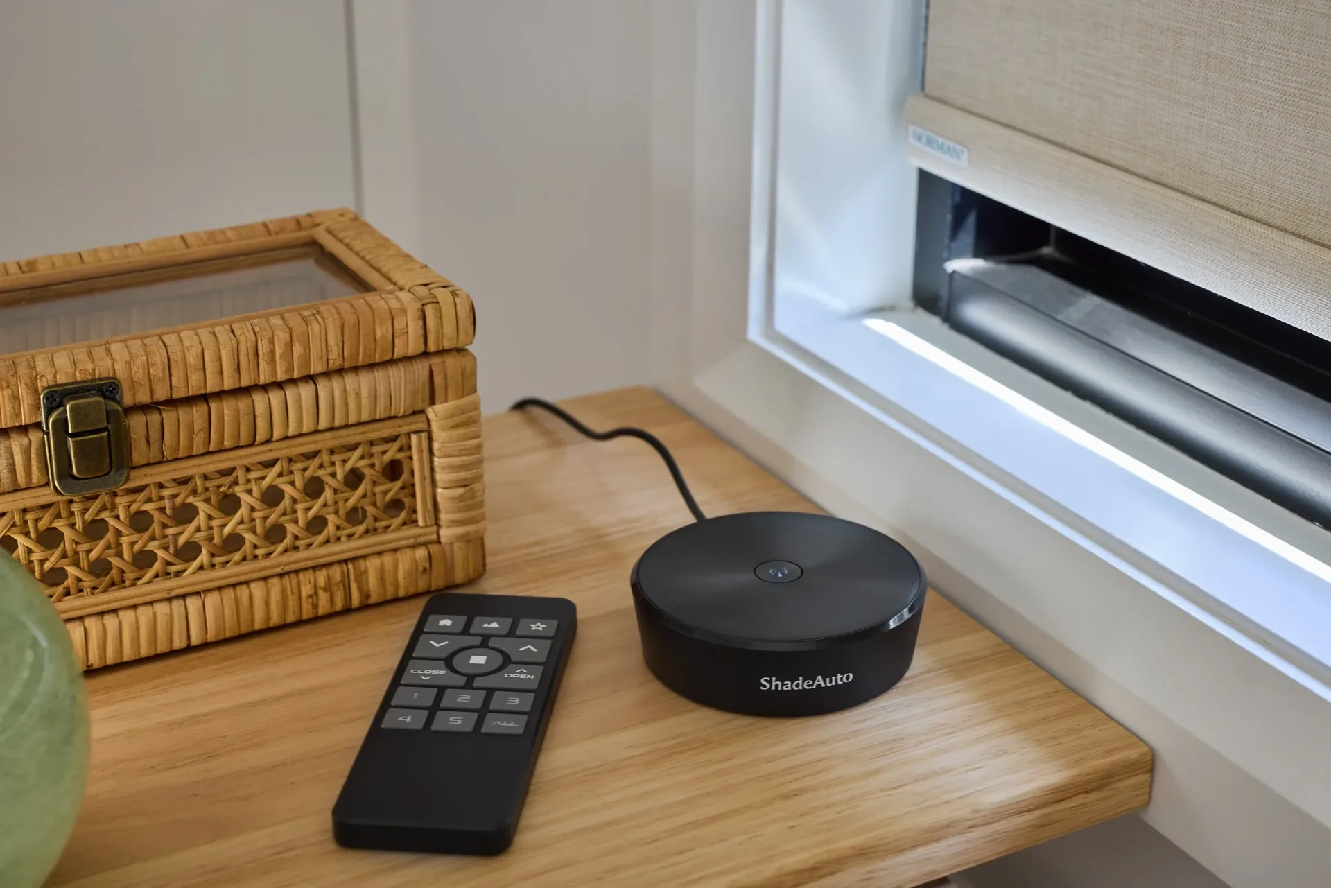 Roller blind and motorisation remote on a timber window sill